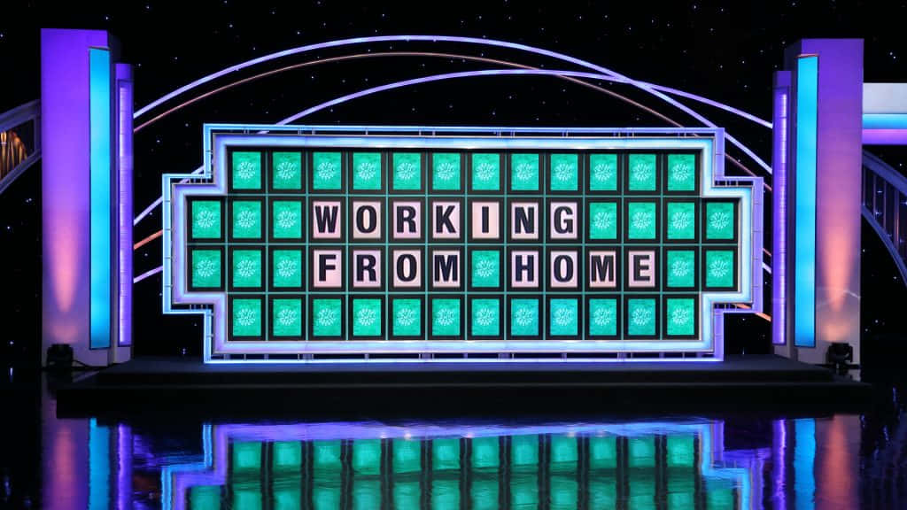 game 桌布 壁紙 — 一個發光的遊戲節目板在星空背景下以粗體字顯示「WORKING FROM HOME」，並帶有紫色和青綠色的燈光。