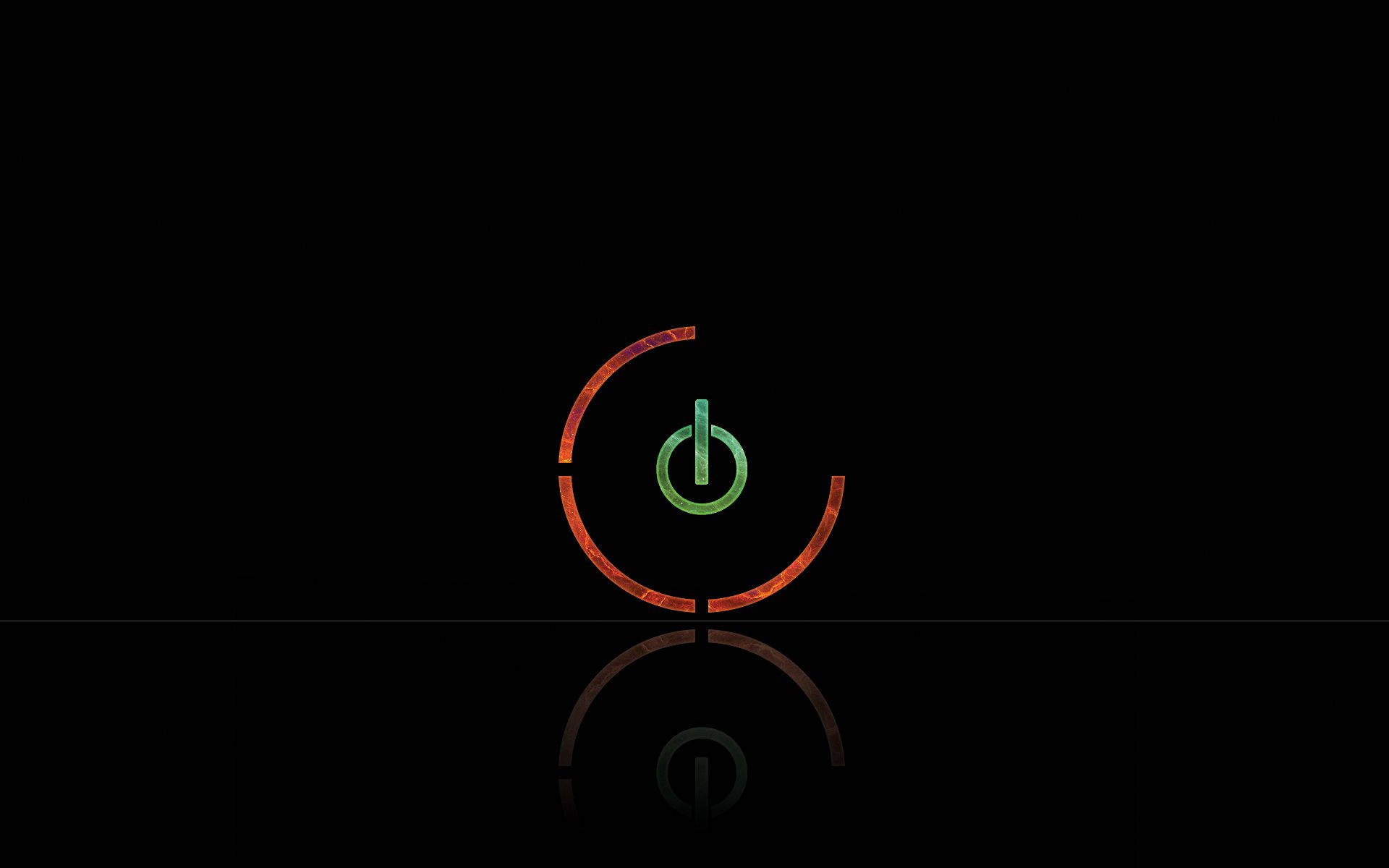 發光電源按鈕圖示在黑色表面上反射。