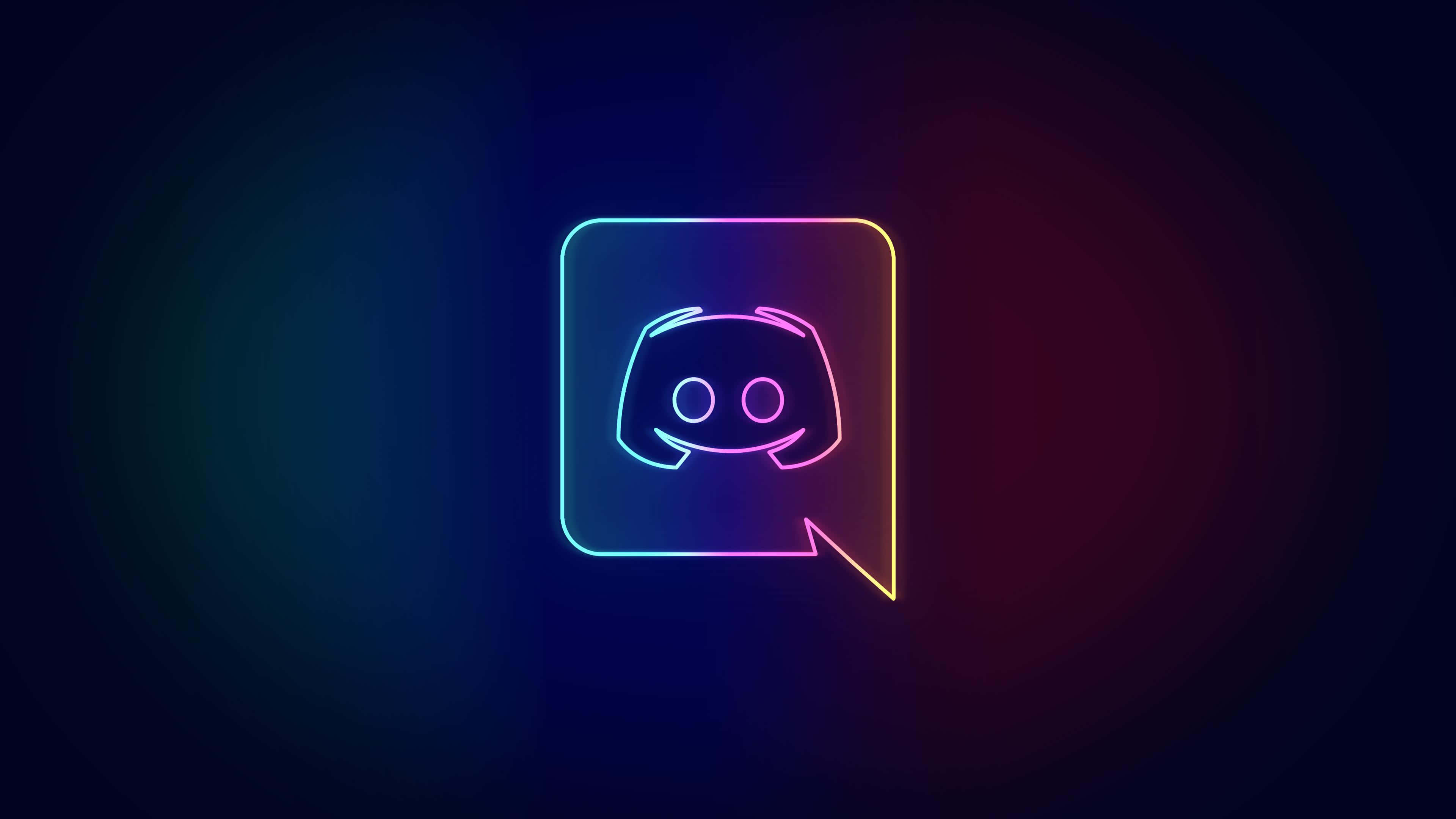 Discord 桌布 壁紙 — 一個發光的霓虹燈Discord標誌在對話氣泡中，在深色漸變背景上散發出鮮豔的彩虹色調。