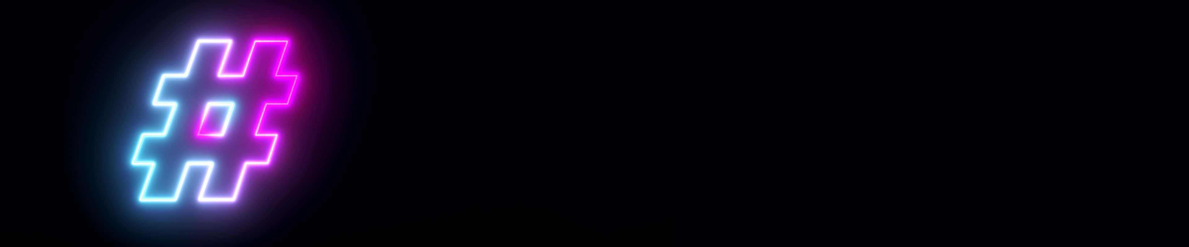 3840x800 桌布 壁紙 — 一個發光的霓虹燈標籤符號在漆黑背景上閃爍著電光藍和粉紅色調。