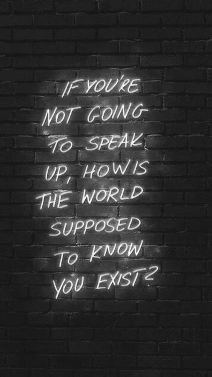 Inspirational Quotes 桌布 壁紙 — 一個發光的霓虹燈牌，白色字母在深色磚牆上，提出一個關於發聲的有力問題。
