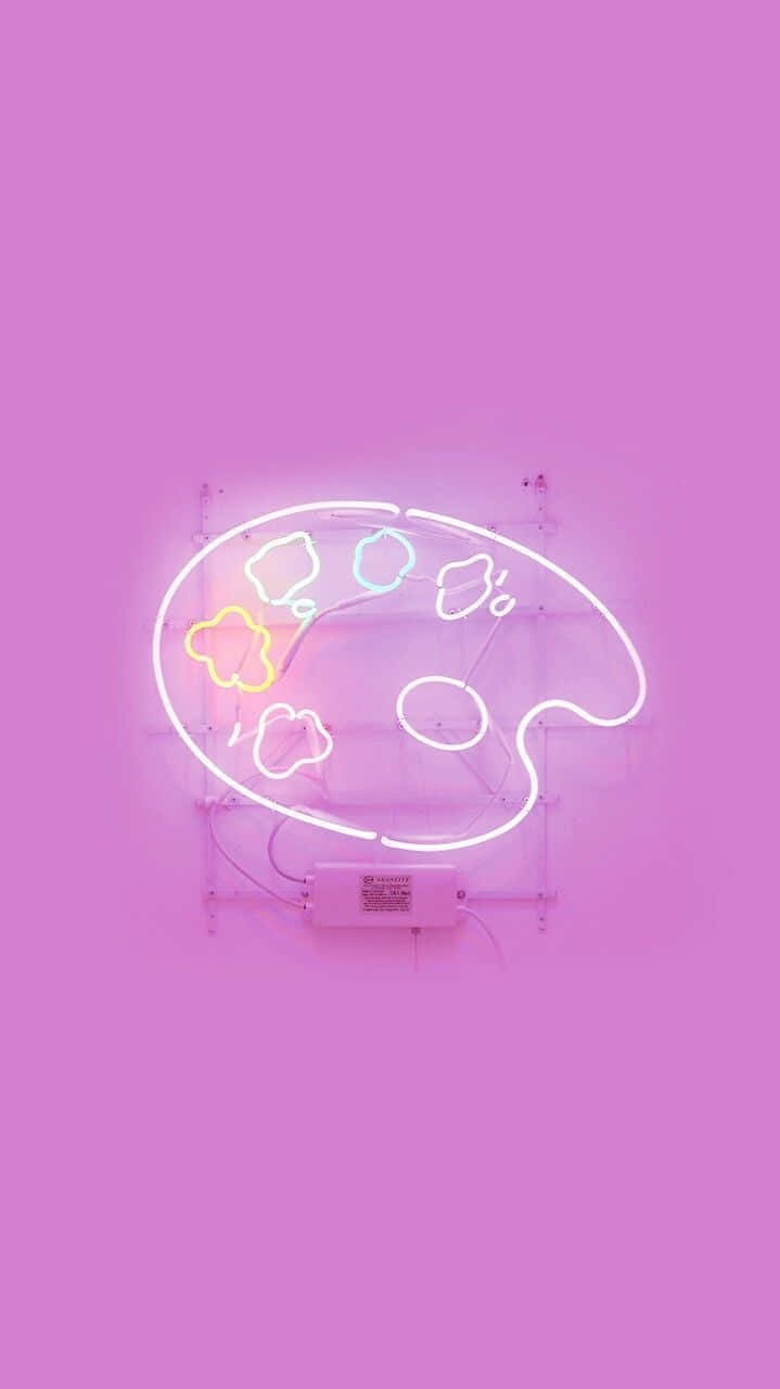Cute Aesthetic iPad 桌布 壁紙 — 一個發光的霓虹藝術調色板，帶有彩色油漆塊，掛在純粉紅色的牆上。