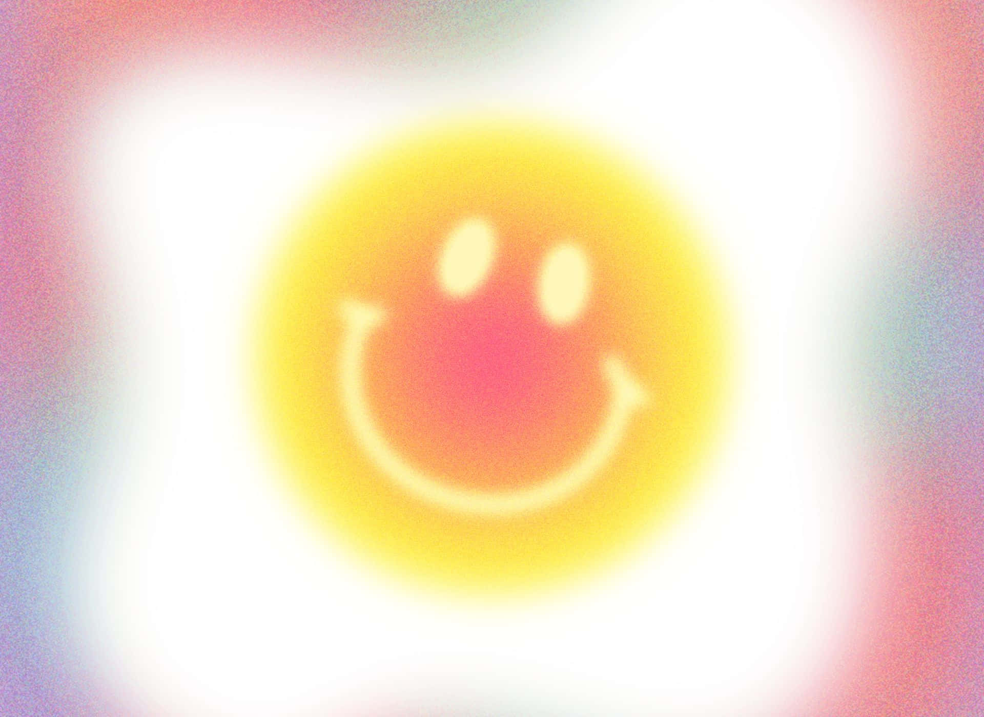 Aura 桌布 壁紙 — 一個發光的黃色笑臉在柔和粉彩漸變背景上散發溫暖。