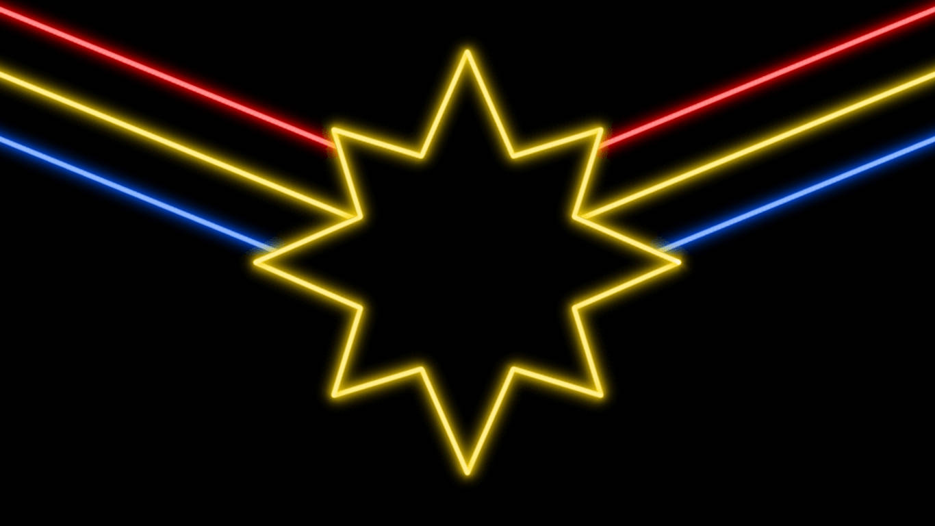Captain Marvel 桌布 壁紙 — 一個發光的黃色霓虹星形輪廓在黑色背景上，紅色、黃色和藍色的霓虹光束向外輻射。