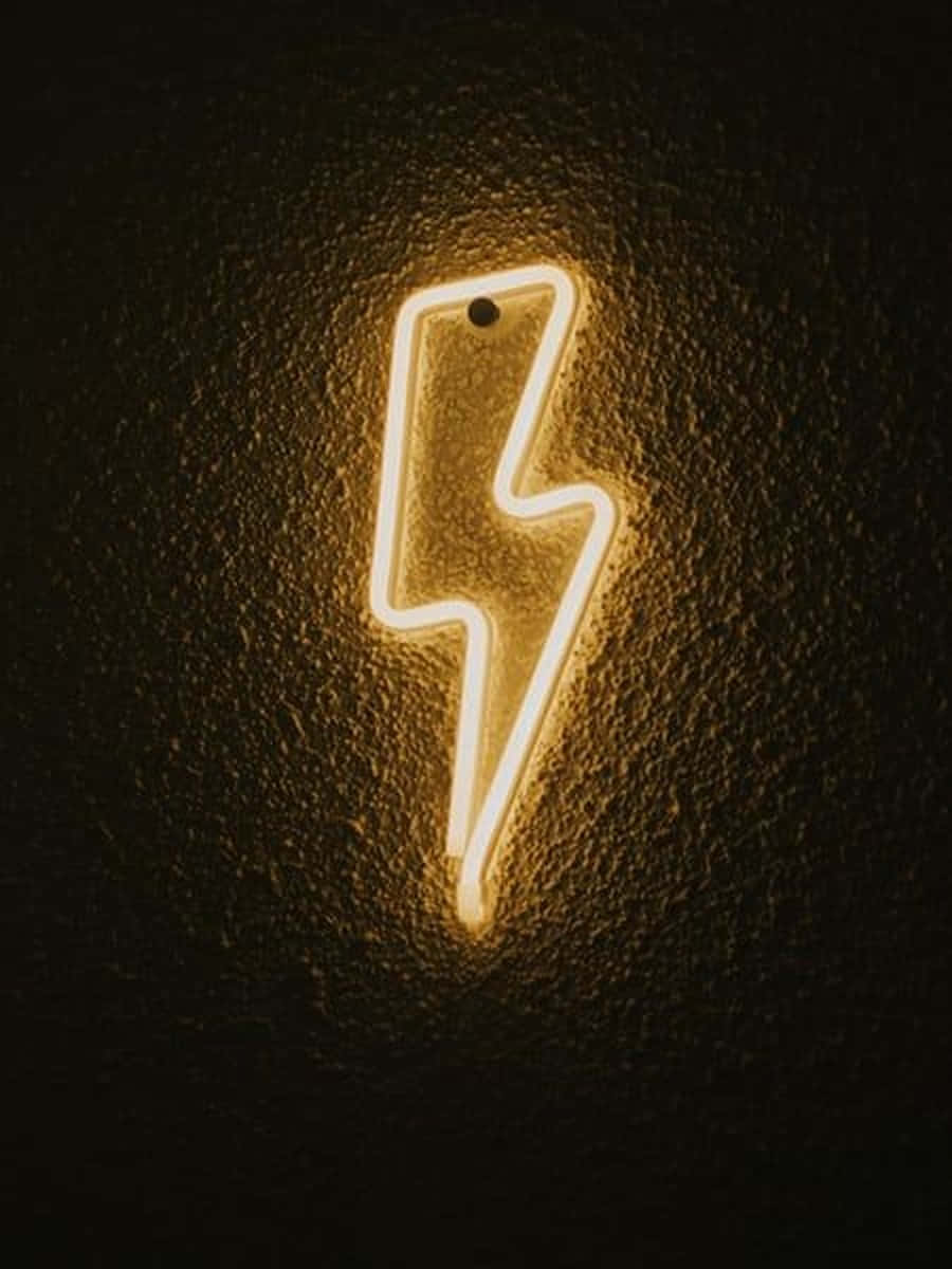 Neon Lightning 桌布 壁紙 — 一個發光的黃色霓虹閃電標誌，在深色紋理牆壁上投射出溫暖的光芒。