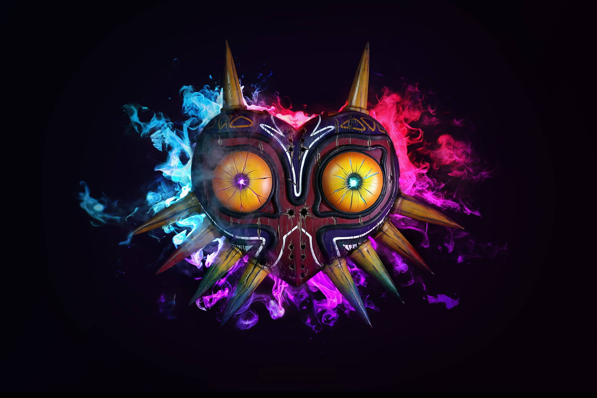 Majora's Mask 桌布 壁紙 — 一個發光面具，帶有火焰般的眼睛，被旋轉的藍色和粉紅色火焰包圍，背景為黑色。