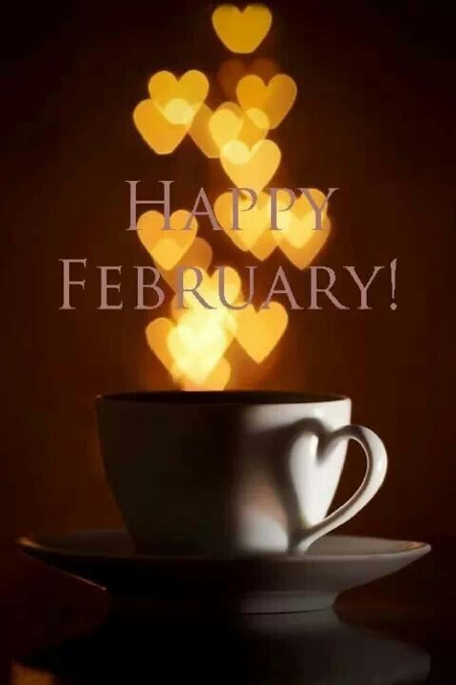 February iPhone 桌布 壁紙 — 一個白色心形咖啡杯在深色背景上散發出發光的金色心形，並帶有「HAPPY FEBRUARY!」文字。