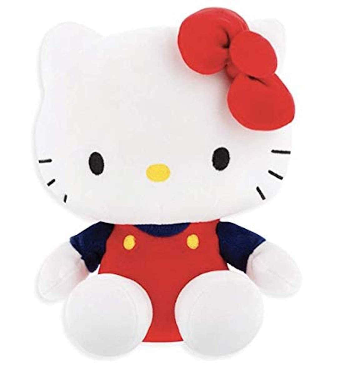 Hello Kitty 桌布 壁紙 — 一個白色毛絨Hello Kitty玩偶，戴著紅色蝴蝶結和紅色吊帶褲，坐在純白色背景前。
