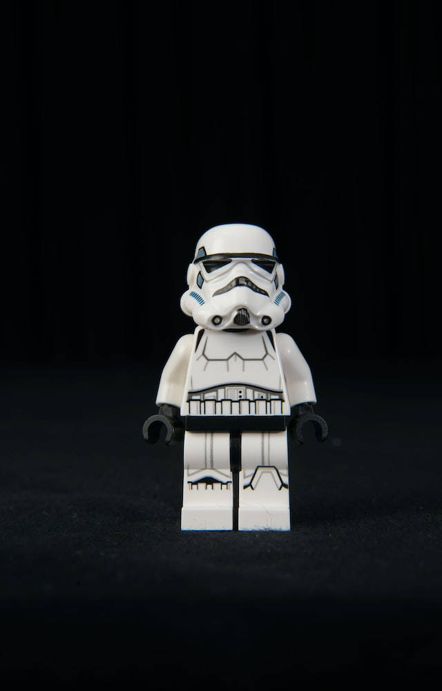 星際大戰 iPhone 桌布 壁紙 — 一個白色的LEGO風暴兵人偶在強烈黑色背景和戲劇性燈光下居中站立。