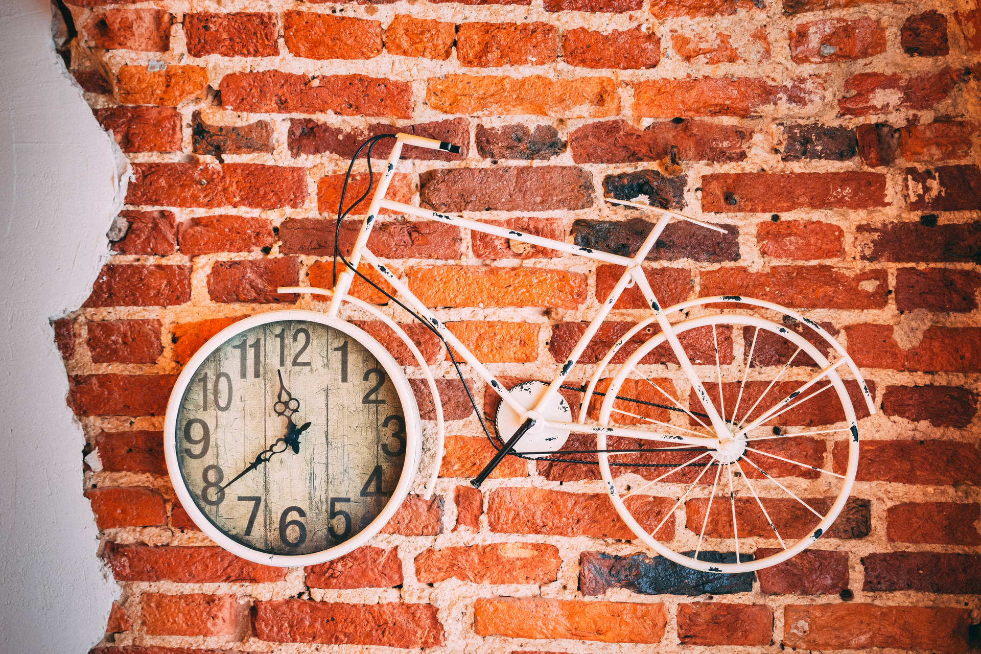 Clock 桌布 壁紙 — 一個白色自行車時鐘安裝在帶有裸露砂漿的質樸紅磚牆上。