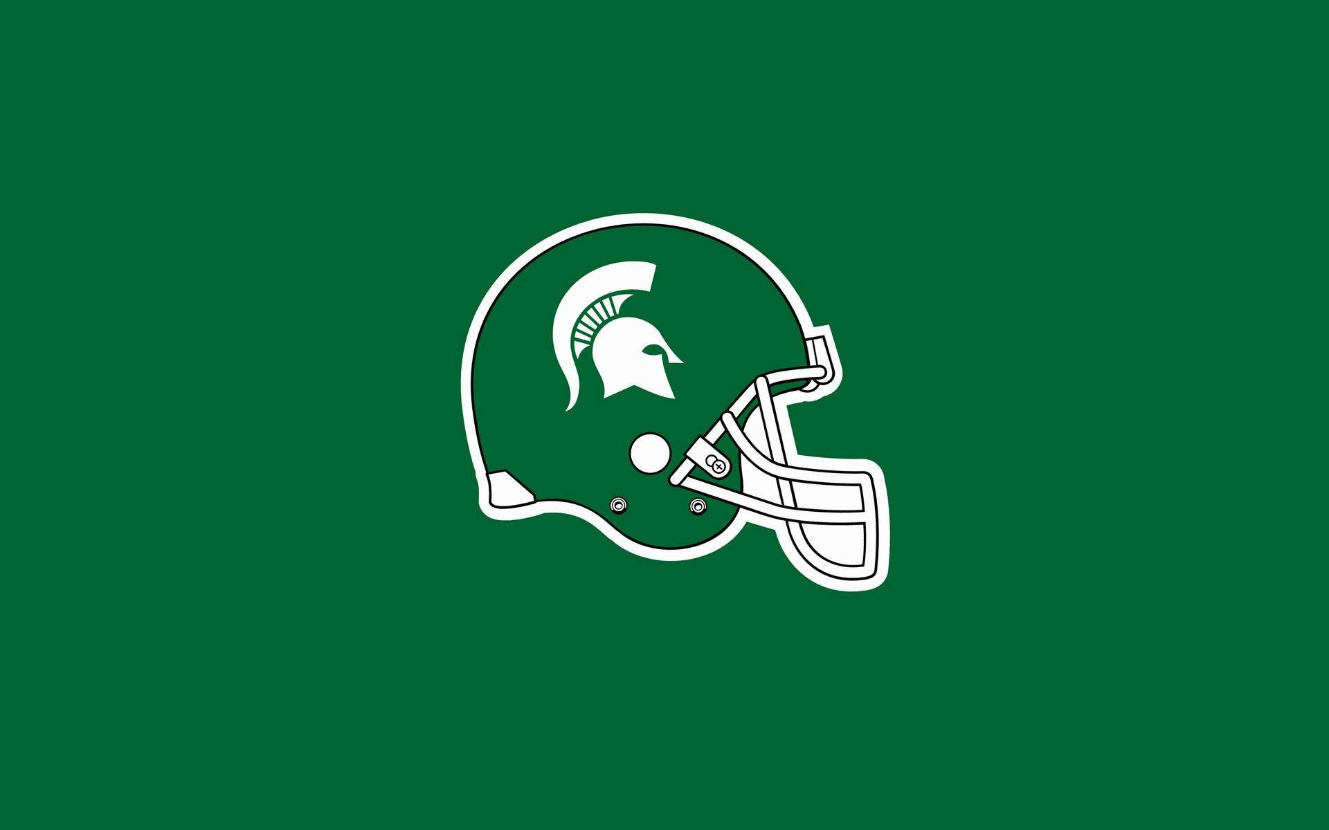 Michigan State Spartans 桌布 壁紙 — 一個白色輪廓的美式足球頭盔，中央有一個斯巴達吉祥物標誌，背景為純綠色。