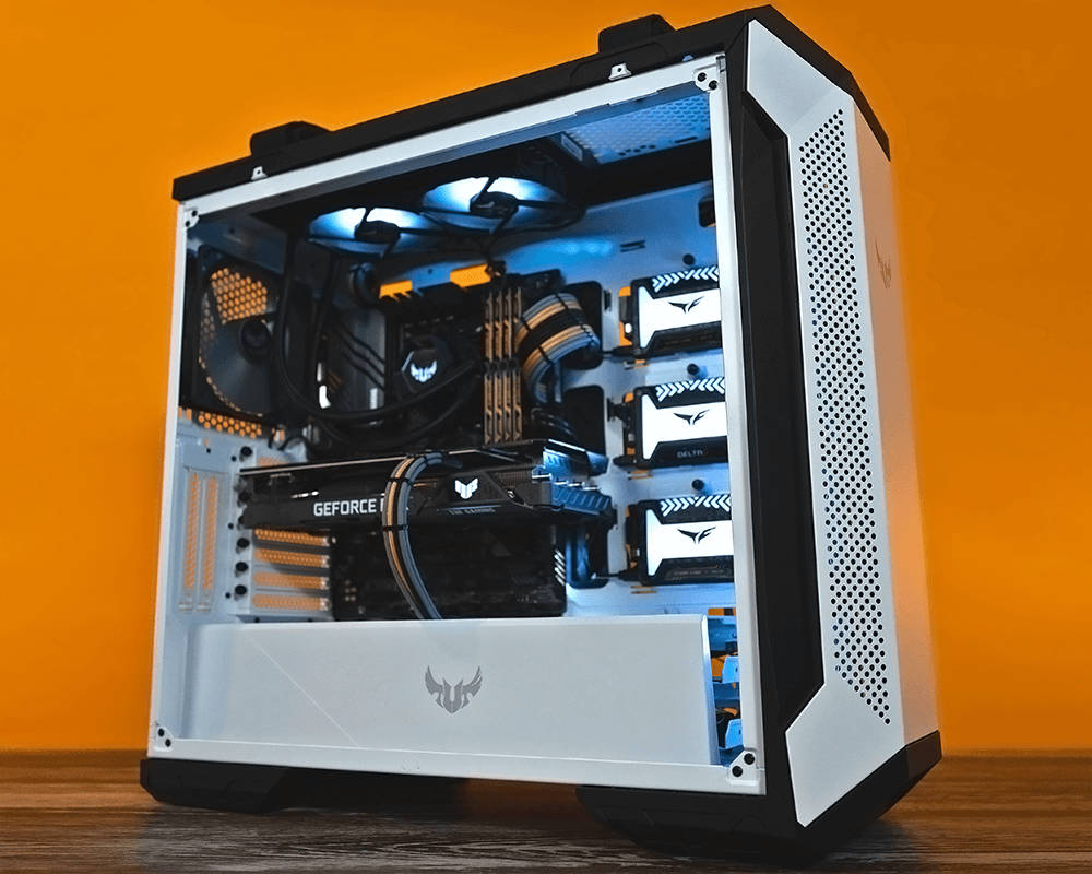 White Pc 桌布 壁紙 — 一個白色電競機殼，配備藍色LED風扇和GeForce顯示卡，放置在木質表面上，背景是鮮豔的橙色牆壁。