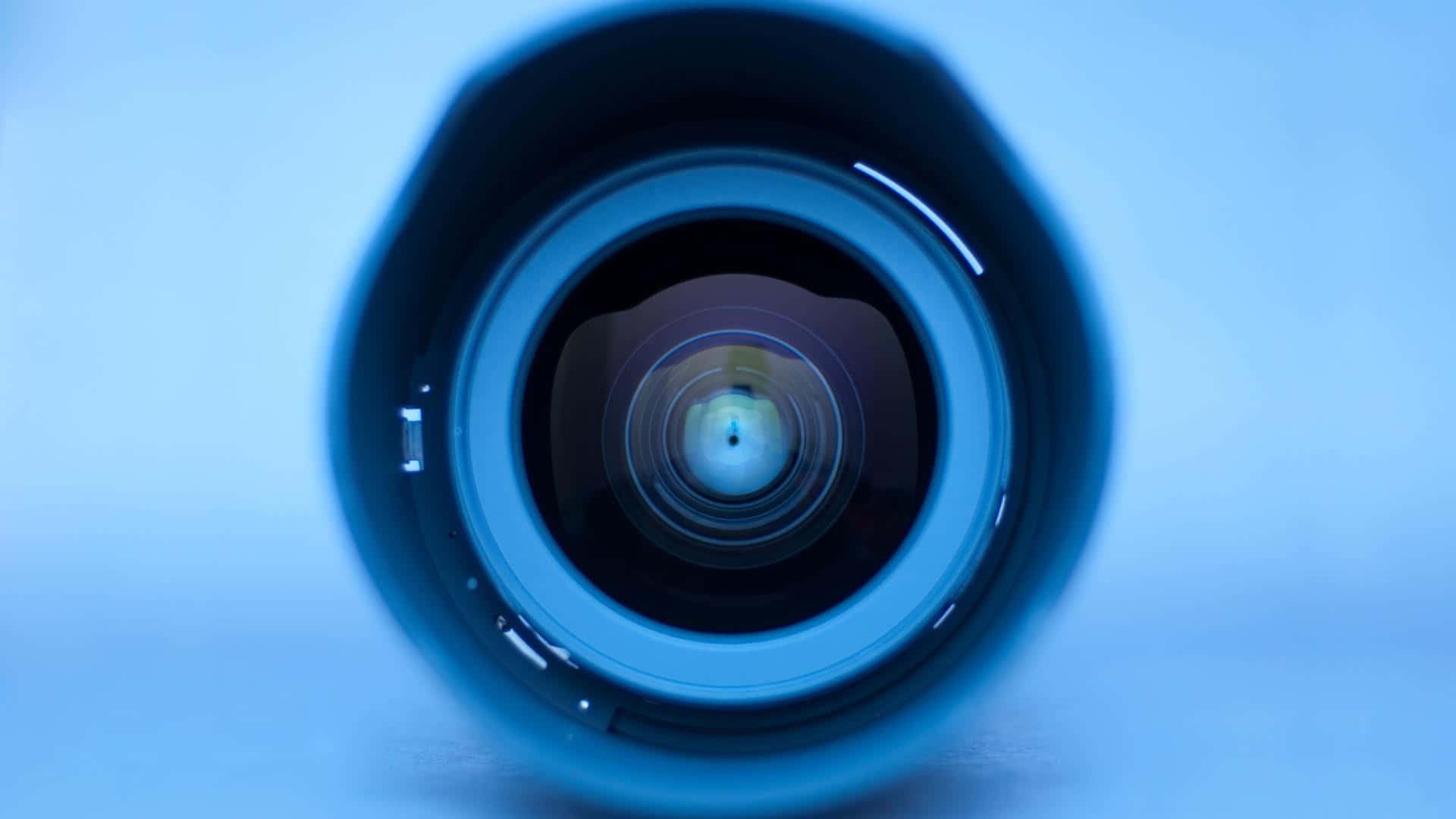 Camera 桌布 壁紙 — 一個相機鏡頭的特寫，景深較淺，背景為柔和的藍色。