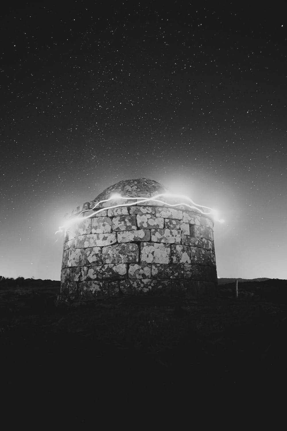Stars 桌布 壁紙 — 一個石製圓頂結構在繁星點點的夜空下發光，明亮的閃電弧環繞其頂部。
