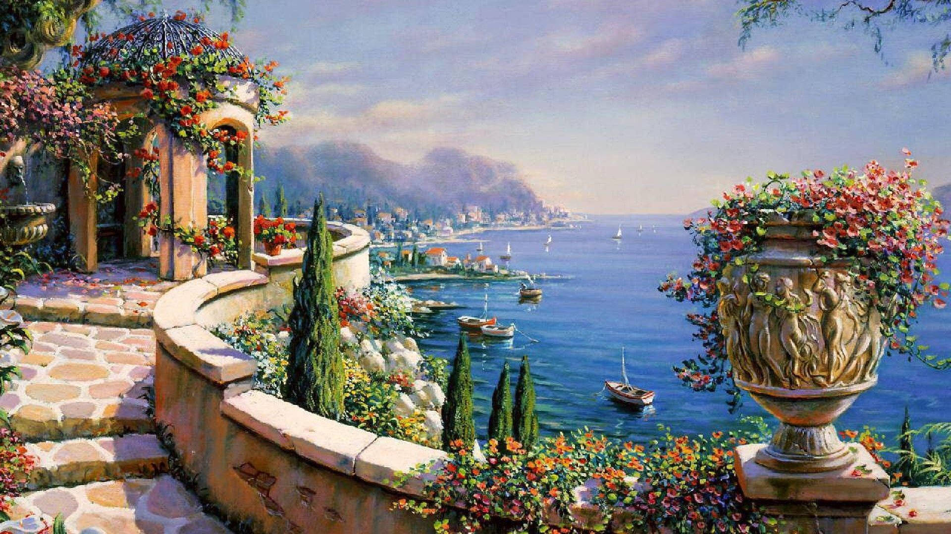 Capri 桌布 壁紙 — 一個石頭露台點綴著盛開的花朵，俯瞰著一個寧靜的沿海小鎮，小船在碧綠的水面上。