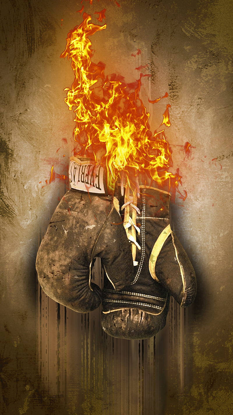 Cool Boxing 桌布 壁紙 — 一個破舊的 Everlast 拳擊手套在粗糙的紋理牆壁上爆發出咆哮的火焰。