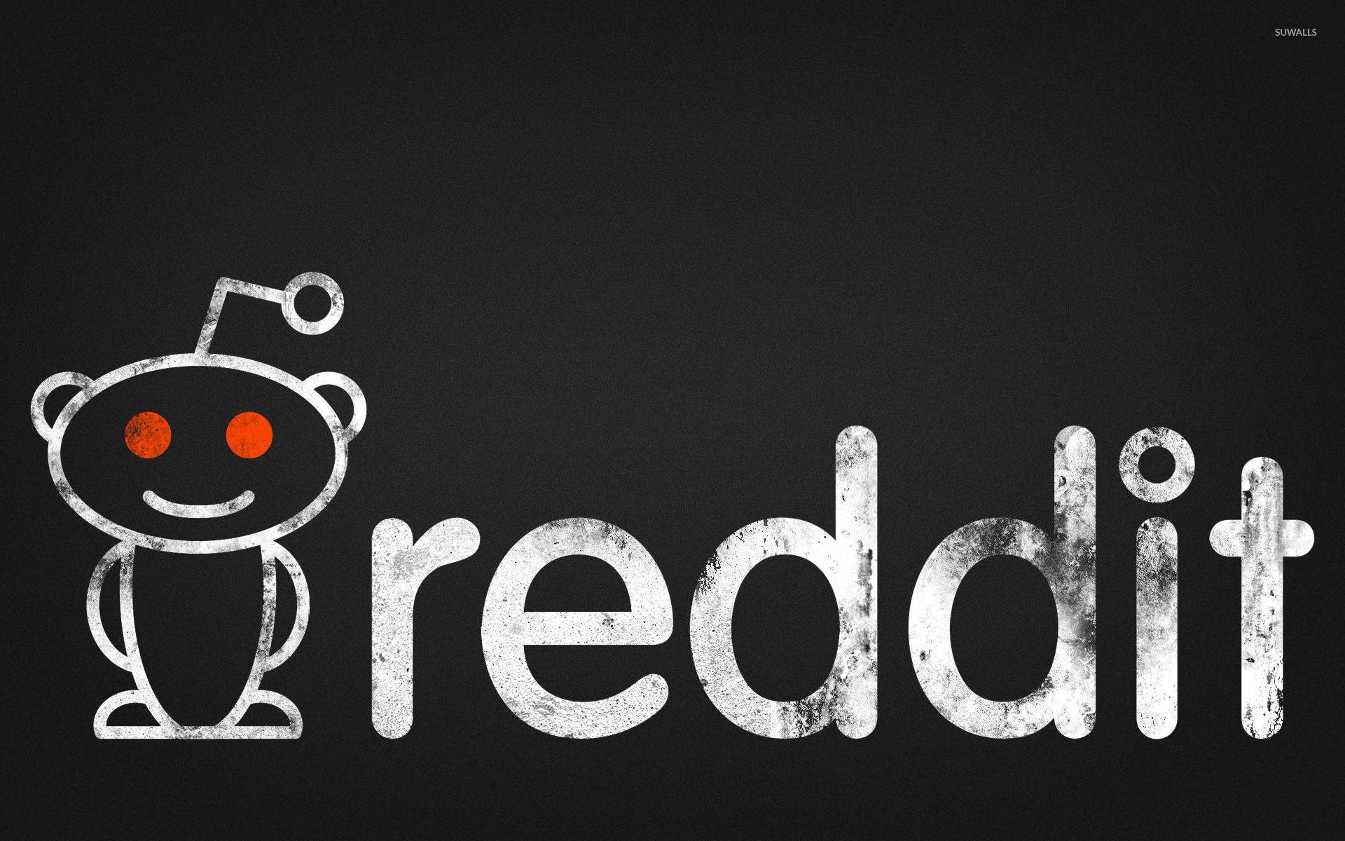 Reddit 桌布 壁紙 — 一個破舊的白色 Reddit 標誌，帶有發光的橙色眼睛，在深色紋理背景上。