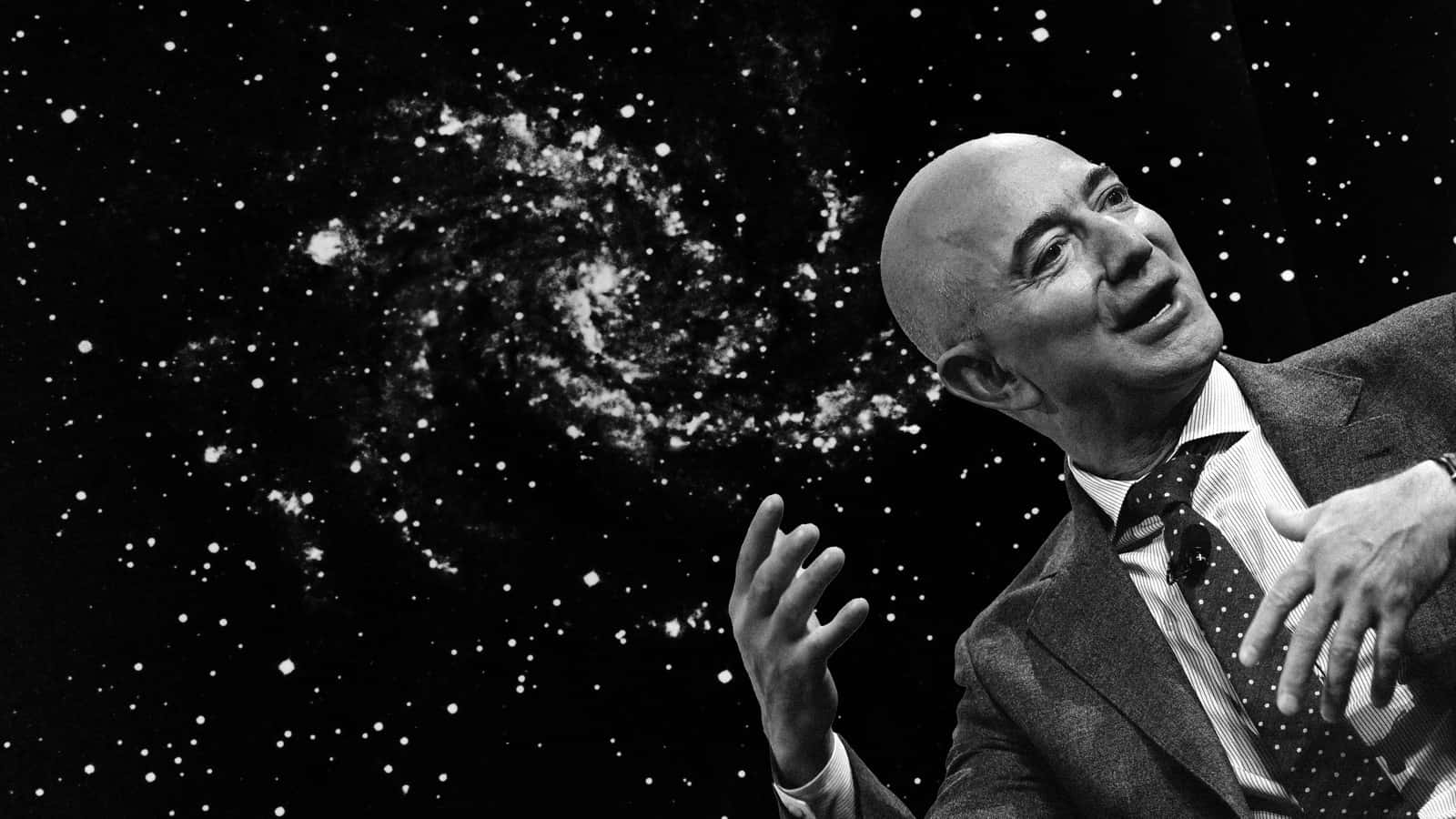 Jeff Bezos 桌布 壁紙 — 一個禿頭穿西裝的男人在一個有螺旋星系的星空宇宙背景下向上做手勢。
