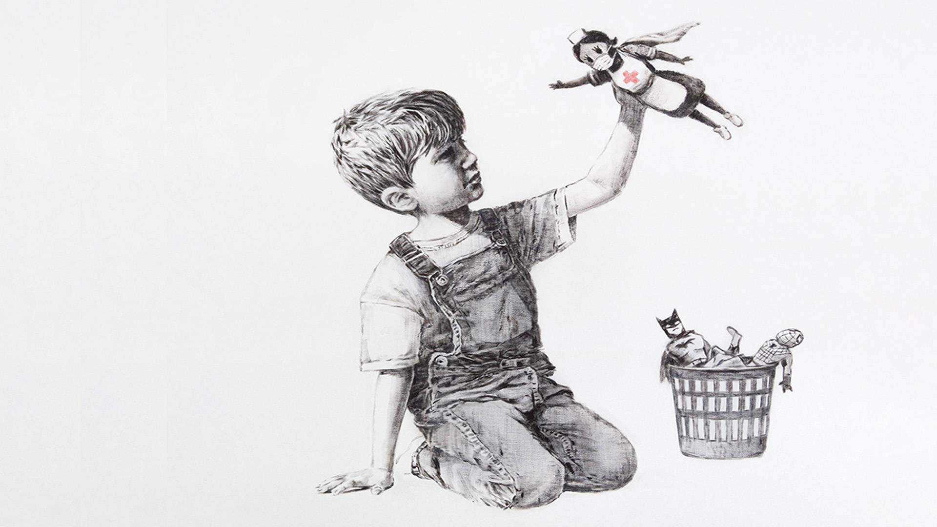 Banksy 桌布 壁紙 — 一個穿著工裝褲的男孩跪著，高舉一個超級英雄玩偶，另一個玩偶則放在他旁邊的洗衣籃裡。