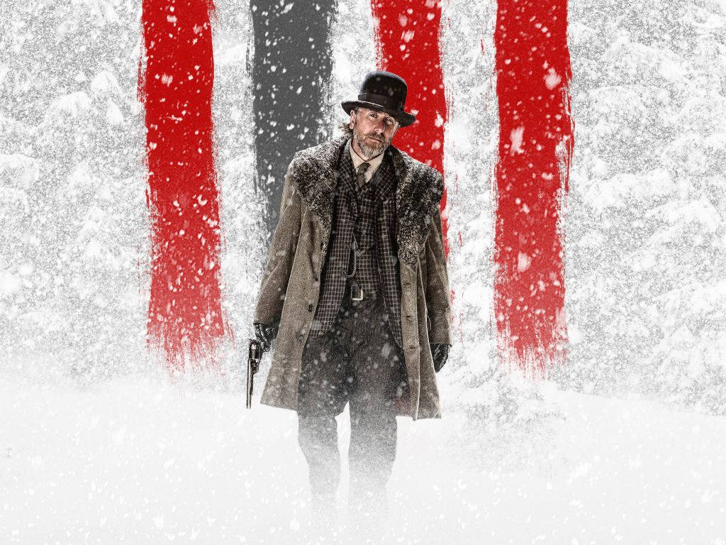 English 桌布 壁紙 — 一個穿著毛領大衣和帽子的男人走過雪景，身後有鮮明的紅色垂直條紋。
