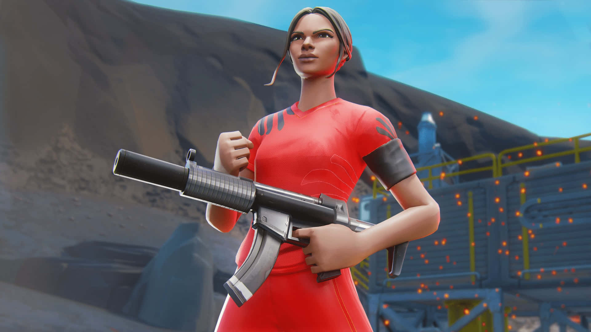Sweaty Soccer Skin 桌布 壁紙 — 一個穿著紅色服裝的女性Fortnite角色，在晴朗的藍天下，以岩石工業背景為襯托，手持衝鋒槍。