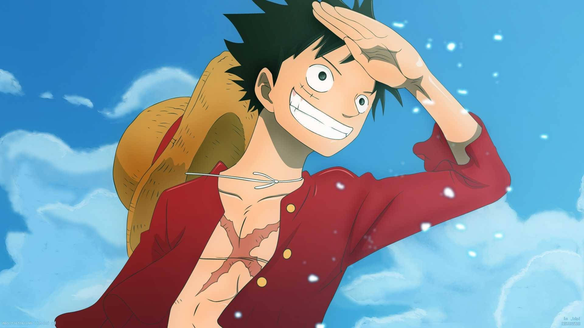luffy 4K 桌布 壁紙 — 一個穿著紅色襯衫和草帽的開朗動漫男孩在晴朗藍天和蓬鬆雲朵下敬禮。