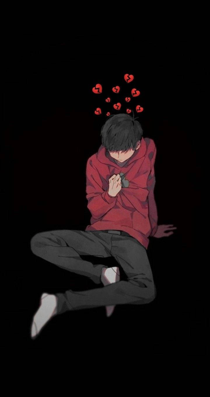 憂鬱少年動漫 桌布 壁紙 — 一個穿著紅色連帽衫的年輕動漫男孩蜷縮著坐著，破碎的心漂浮在他的頭頂上，背景是黑色的。