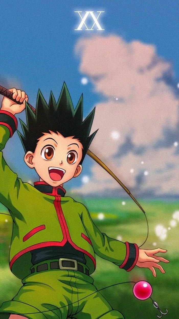 Cute Anime Boy 桌布 壁紙 — 一個穿著綠色衣服的開朗動畫男孩，在藍天白雲下快樂地放著粉紅色氣球。
