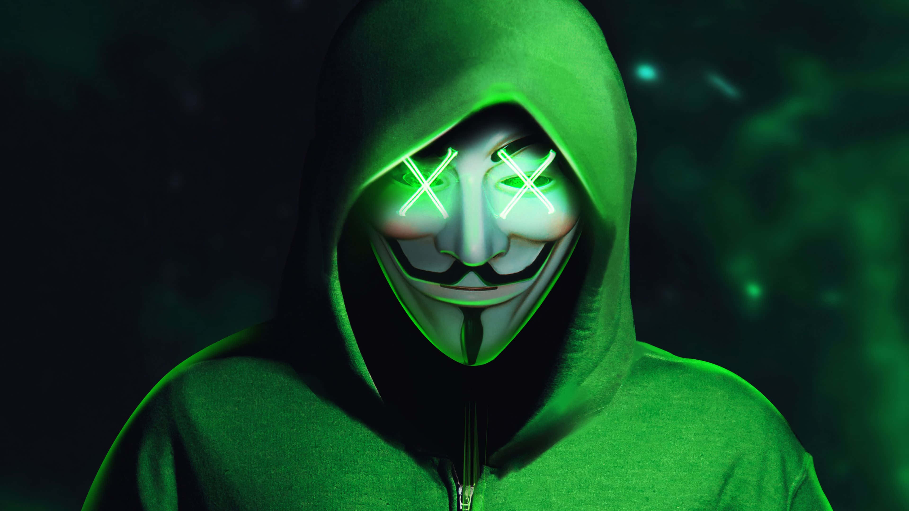 Hoodie 桌布 壁紙 — 一個穿著綠色連帽衫的人戴著發光的白色蓋伊·福克斯面具，面具上有霓虹X眼睛，背景是深綠色。