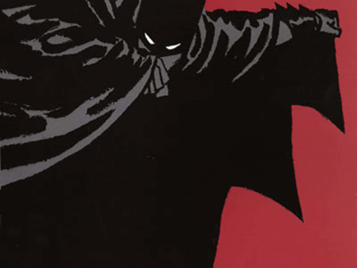 Batman Year One 桌布 壁紙 — 一個穿著黑色、眼睛發出白光的蝙蝠狀威脅人物，站在大膽的紅色背景前。