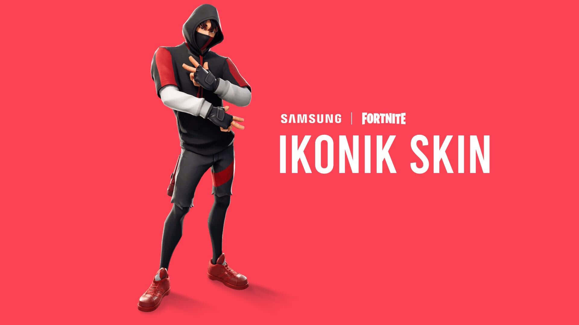 Fortnite Ikonik Skin 桌布 壁紙 — 一個穿著黑色、紅色和灰色連帽衫和面具的Fortnite角色在純紅色背景前擺姿勢，帶有三星品牌標誌。
