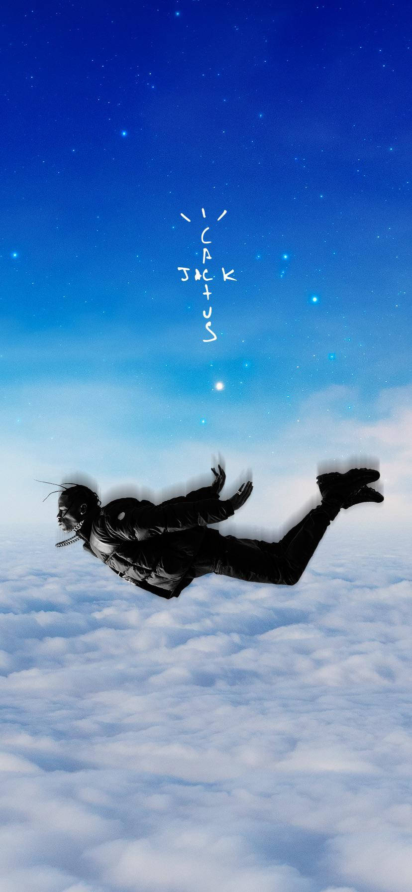 崔維斯·史考特 桌布 壁紙 — 一個穿著黑色外套的人漂浮在蓬鬆的雲層之上，下方是繁星點點的藍色天空，上方寫著「I C A K J A C U S」。