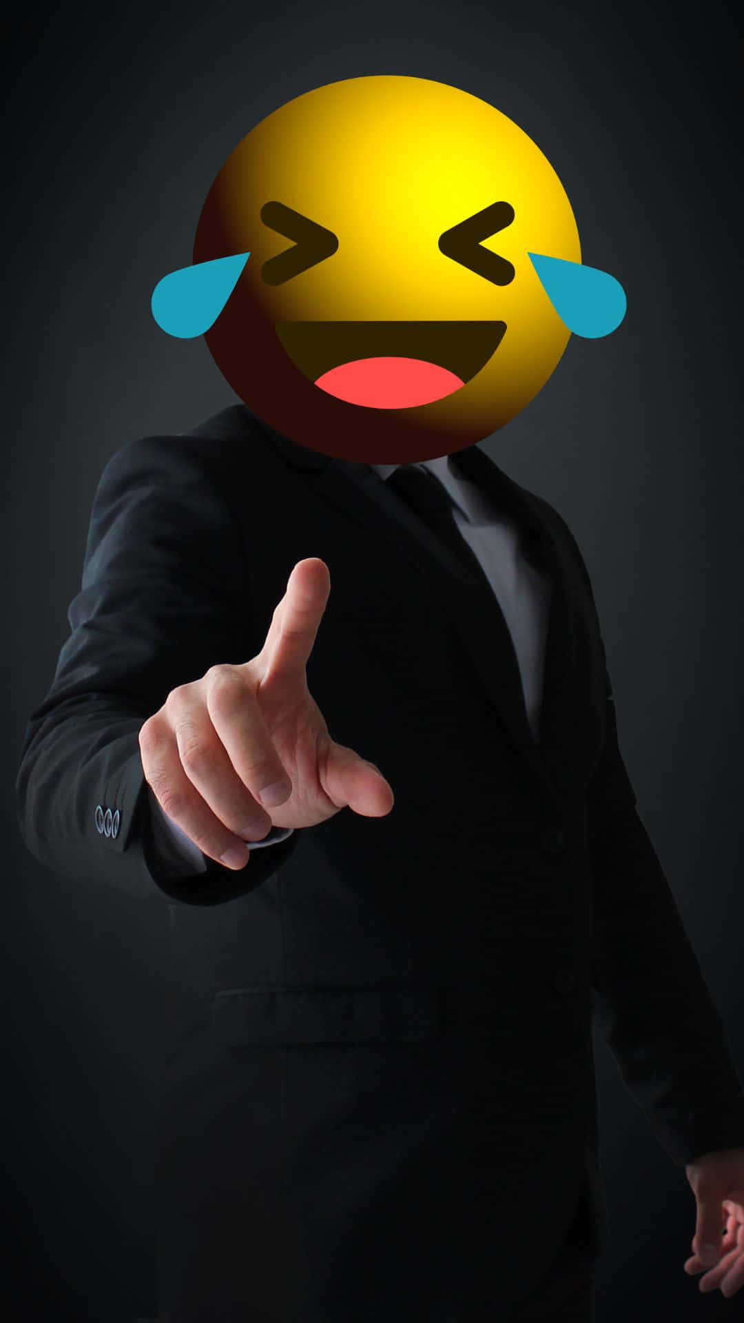 Happy iPhone 桌布 壁紙 — 一個穿著黑色西裝的男人在深色背景前指向前方，頭部被一個笑哭表情符號取代。