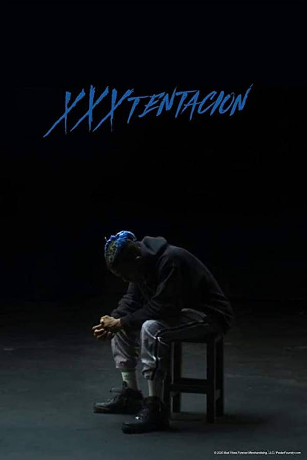 酷酷的xxxtentacion 桌布 壁紙 — 一個穿連帽衫的男人癱坐在黑暗中的凳子上，上方有藍色塗鴉風格文字。