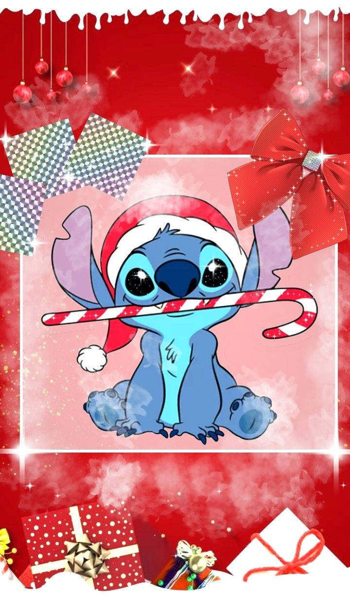 Stitch Disney 桌布 壁紙 — 一個節日卡通史迪奇戴著聖誕帽，拿著拐杖糖，周圍有紅色蝴蝶結、禮物和懸掛的裝飾品，背景是閃閃發光的紅色。