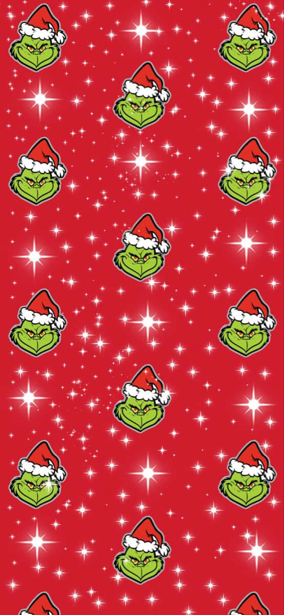 Cute Grinch 桌布 壁紙 — 一個節日紅色壁紙圖案，重複出現戴聖誕帽的卡通鬼靈精面孔和閃爍的白色星星。