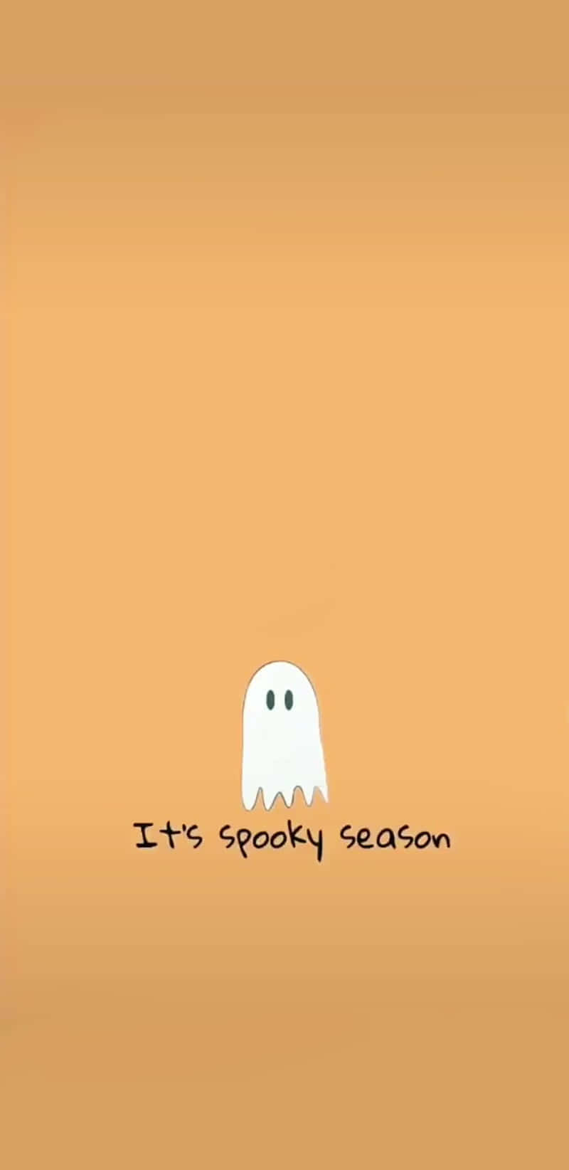 Spooky Season 桌布 壁紙 — 一個簡單的白色卡通鬼魂，有兩隻眼睛，漂浮在純橙色背景上，下方有文字「It's spooky season」。