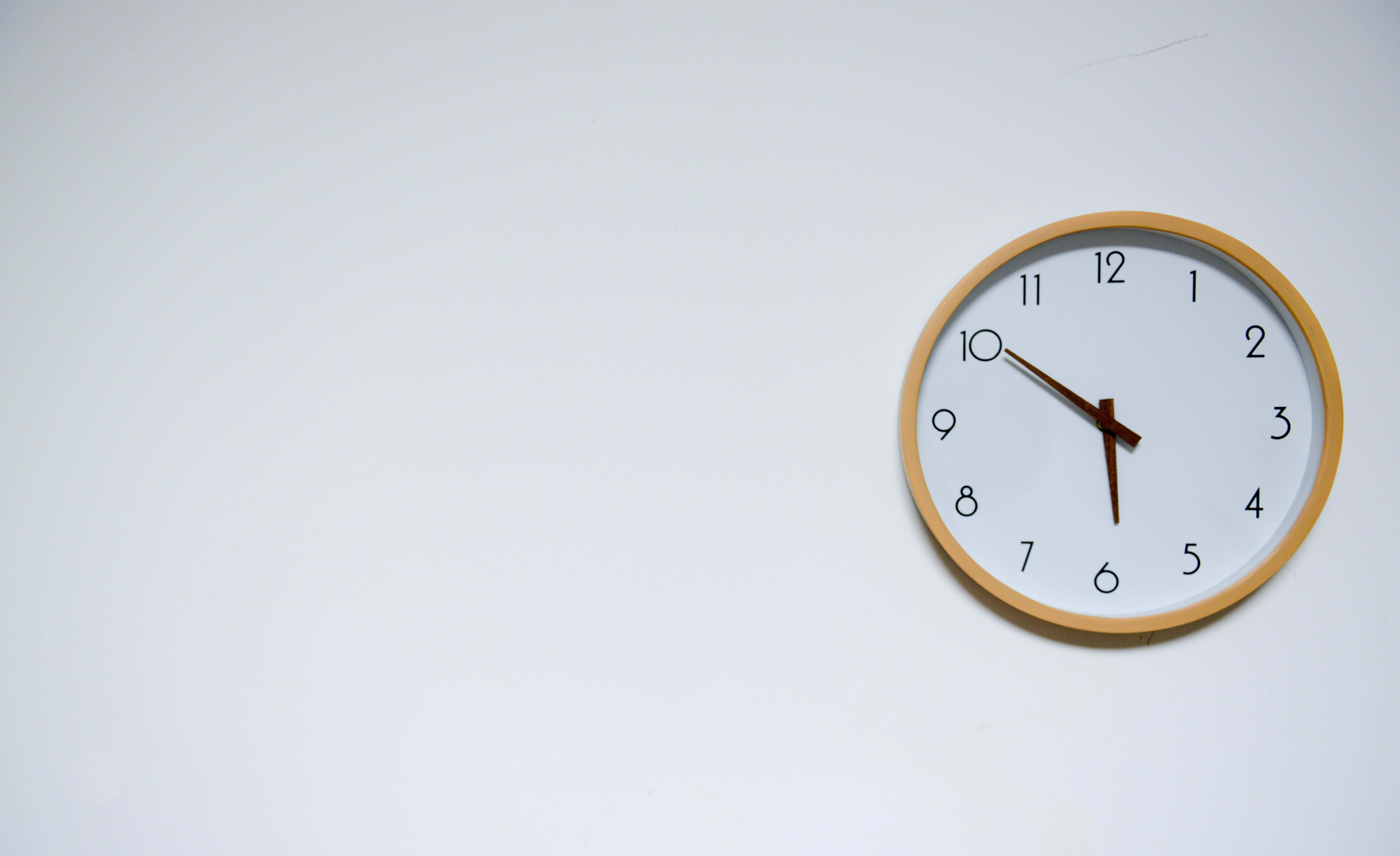Clock 桌布 壁紙 — 一個簡約木框掛鐘在純白背景上顯示5:50。