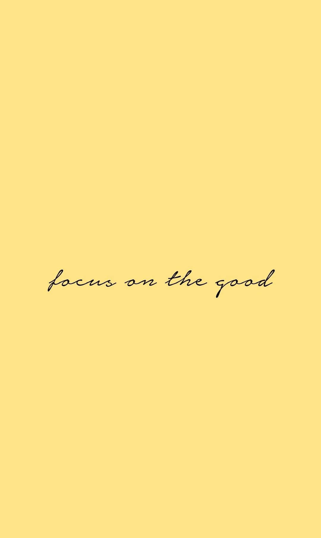 Positive 桌布 壁紙 — 一個簡約的淡黃色背景，下方中央以優雅的黑色草書顯示「專注於美好」這句話。