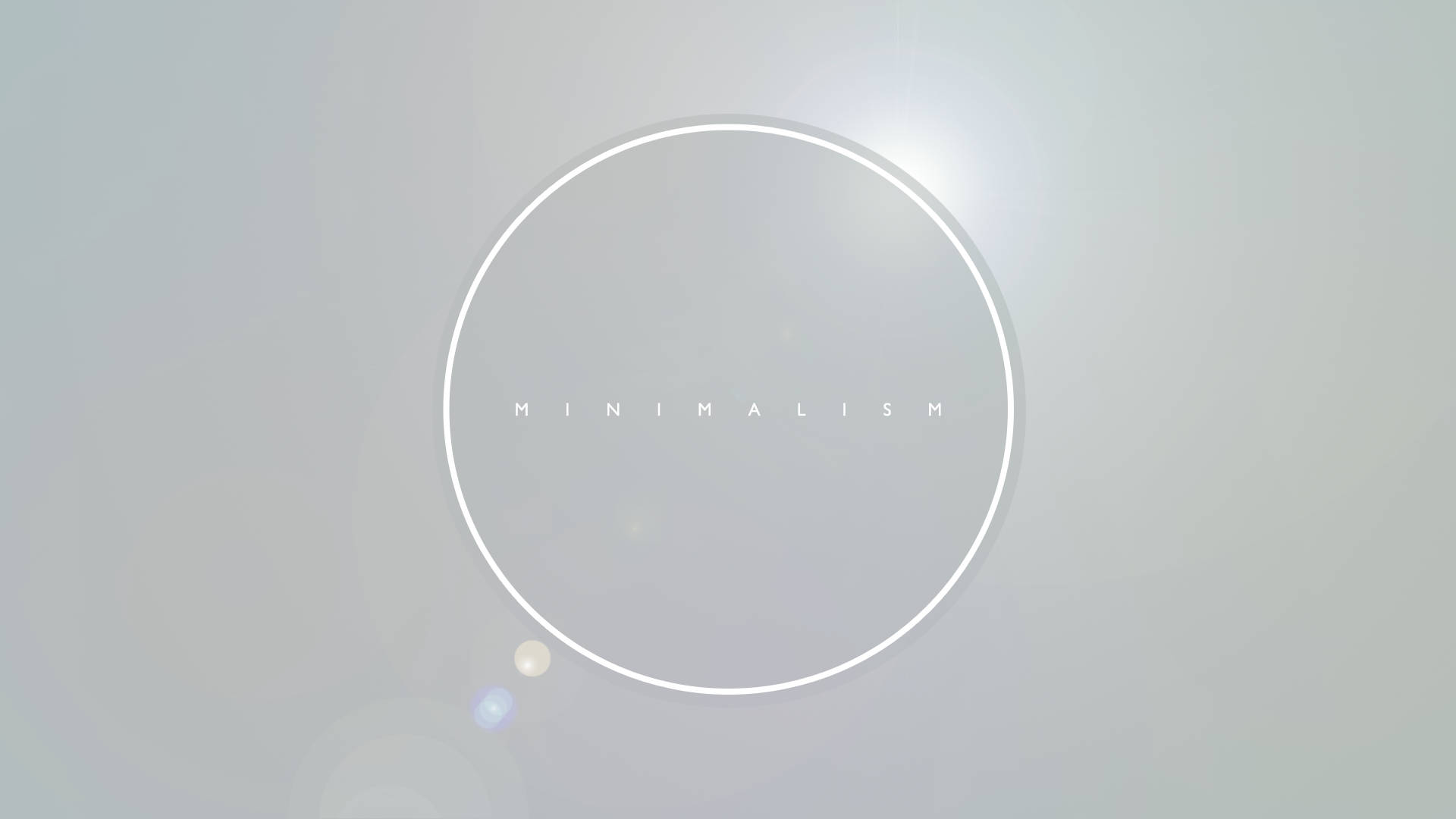 Clean 桌布 壁紙 — 一個簡約的白色圓圈，內有「minimalism」一詞，在帶有鏡頭光暈的漸變灰色背景上柔和發光。