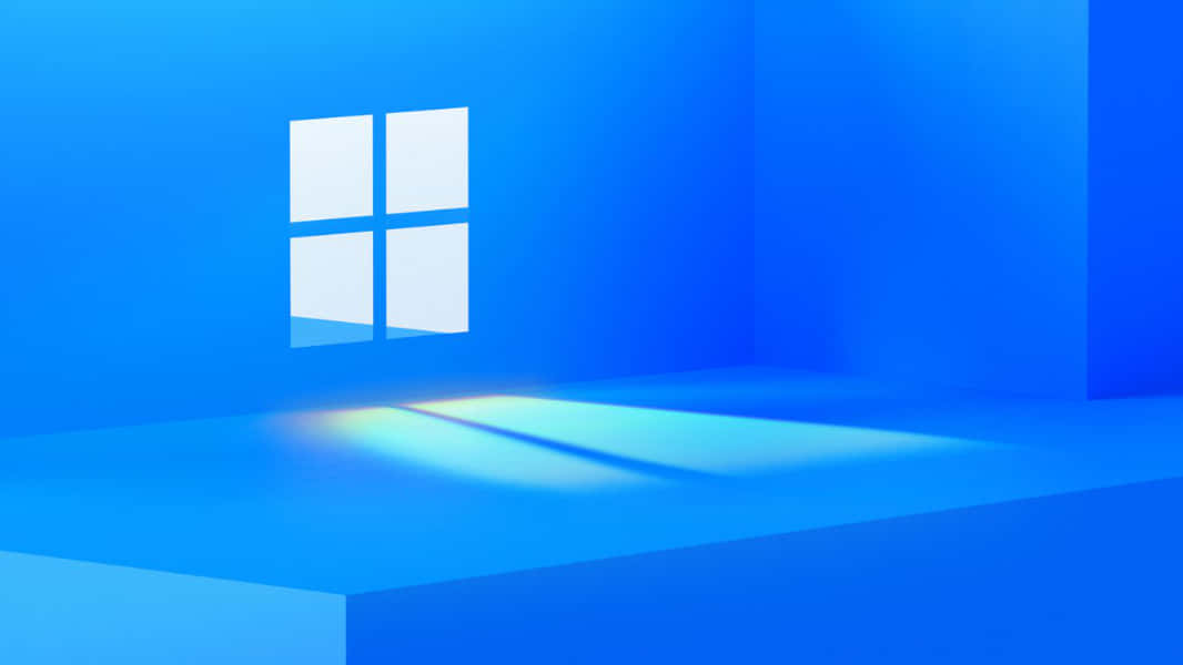 Cool Windows Desktop 桌布 壁紙 — 一個簡約的藍色房間，發光的Windows標誌在地板上投射出柔和的光線。