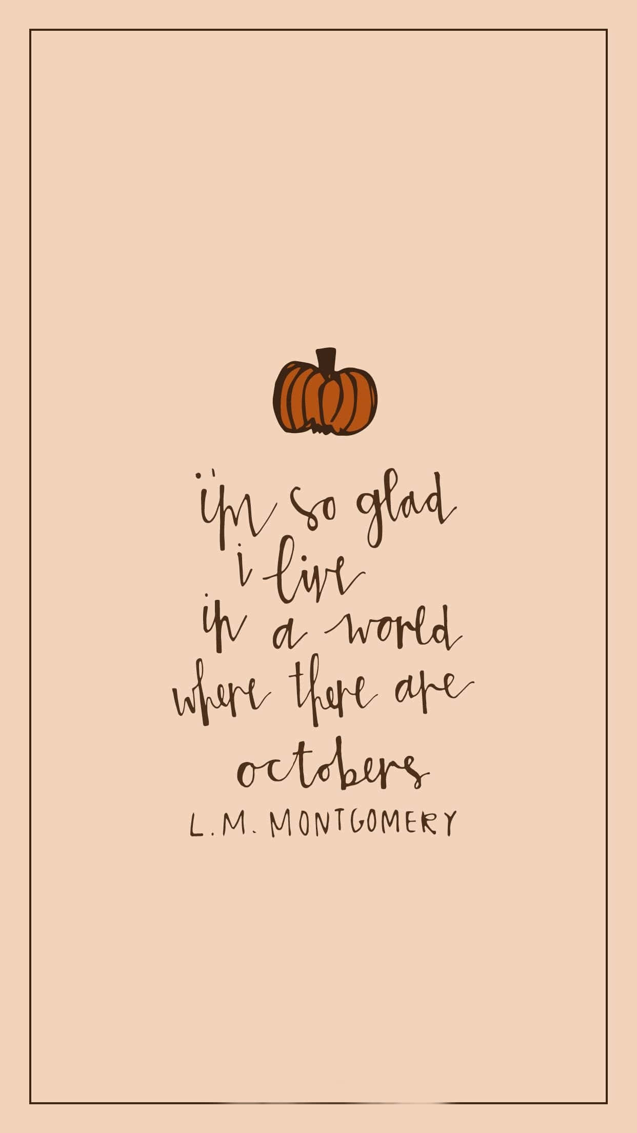 Hello October With Pumpkin 桌布 壁紙 — 一個簡約的蜜桃色背景，上方有手寫文字引用L M Montgomery關於喜愛十月的句子，並配有一個小橙色南瓜。