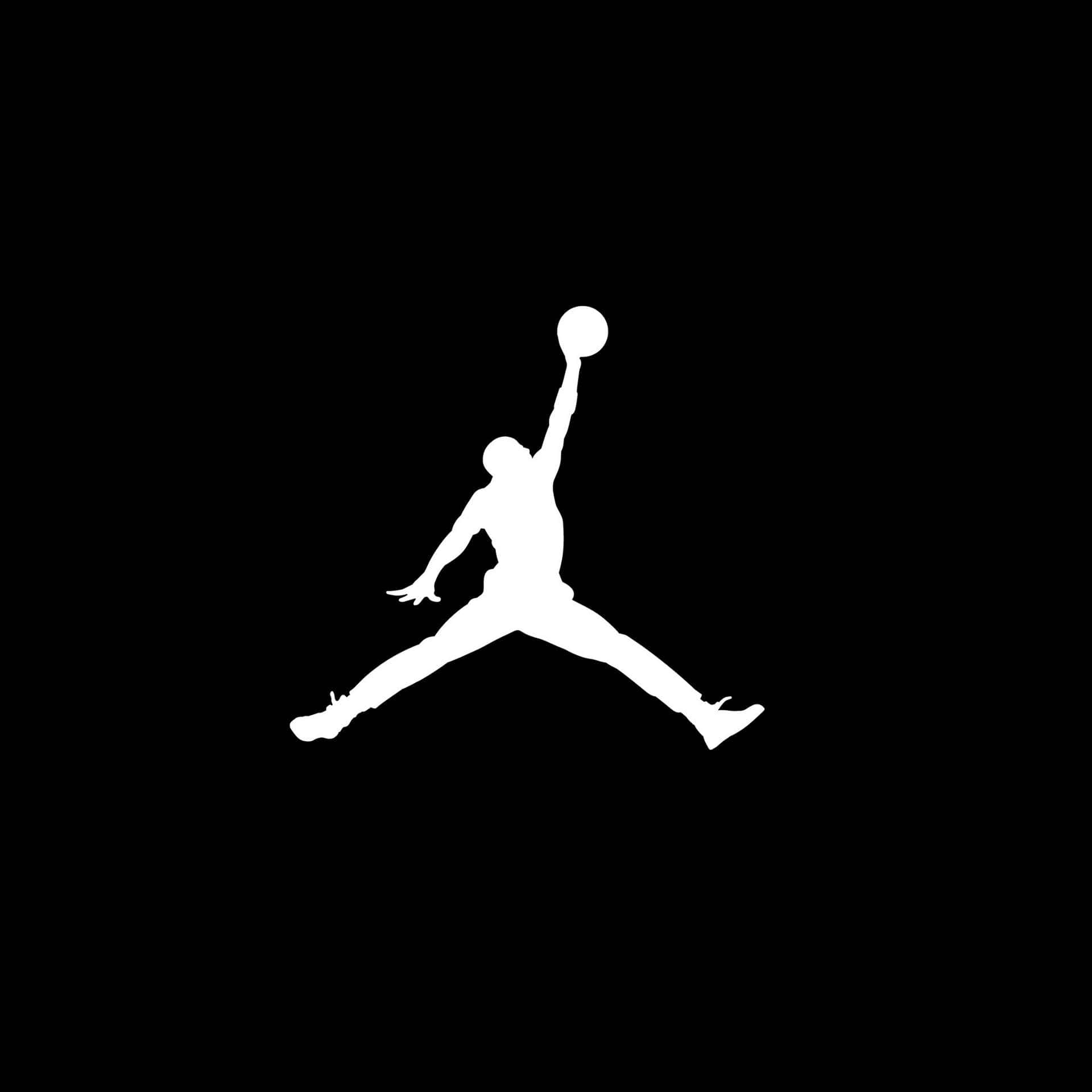 Basketball Logo 桌布 壁紙 — 一個籃球運動員在半空中灌籃的鮮明白色剪影，背景為純黑色。