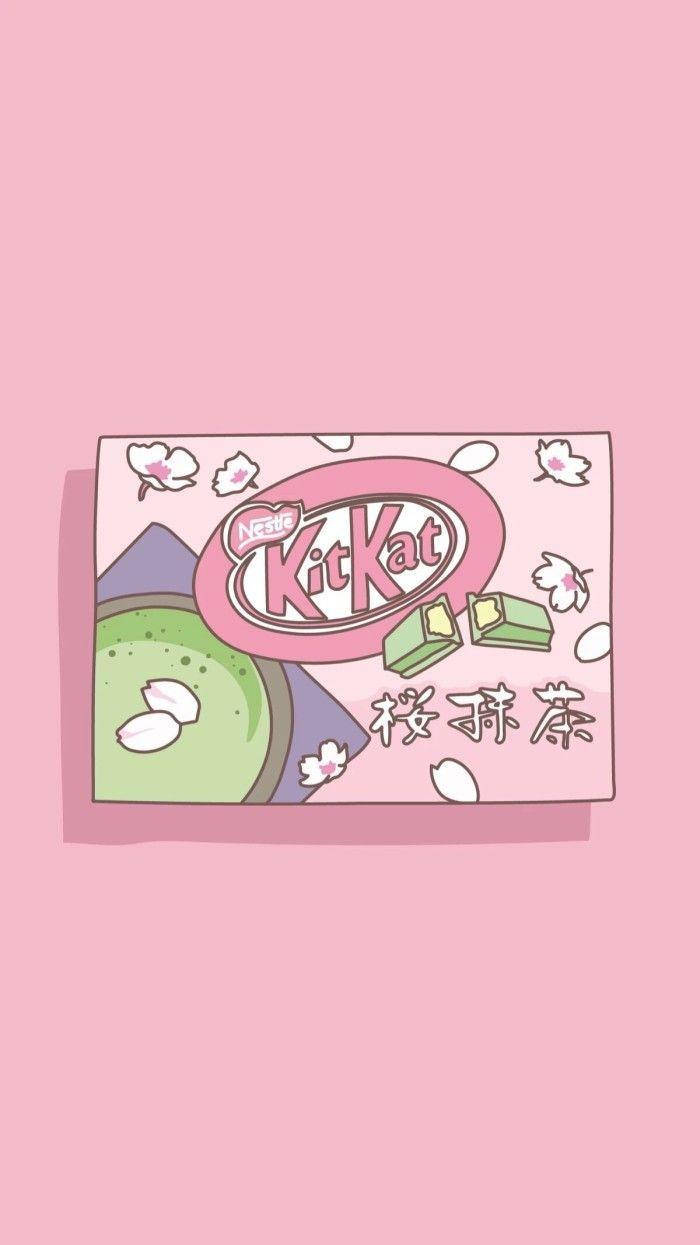 Kawaii iPhone 桌布 壁紙 — 一個粉紅色插圖風格的KitKat盒子，帶有抹茶和櫻花設計，置於柔和粉紅色背景上。