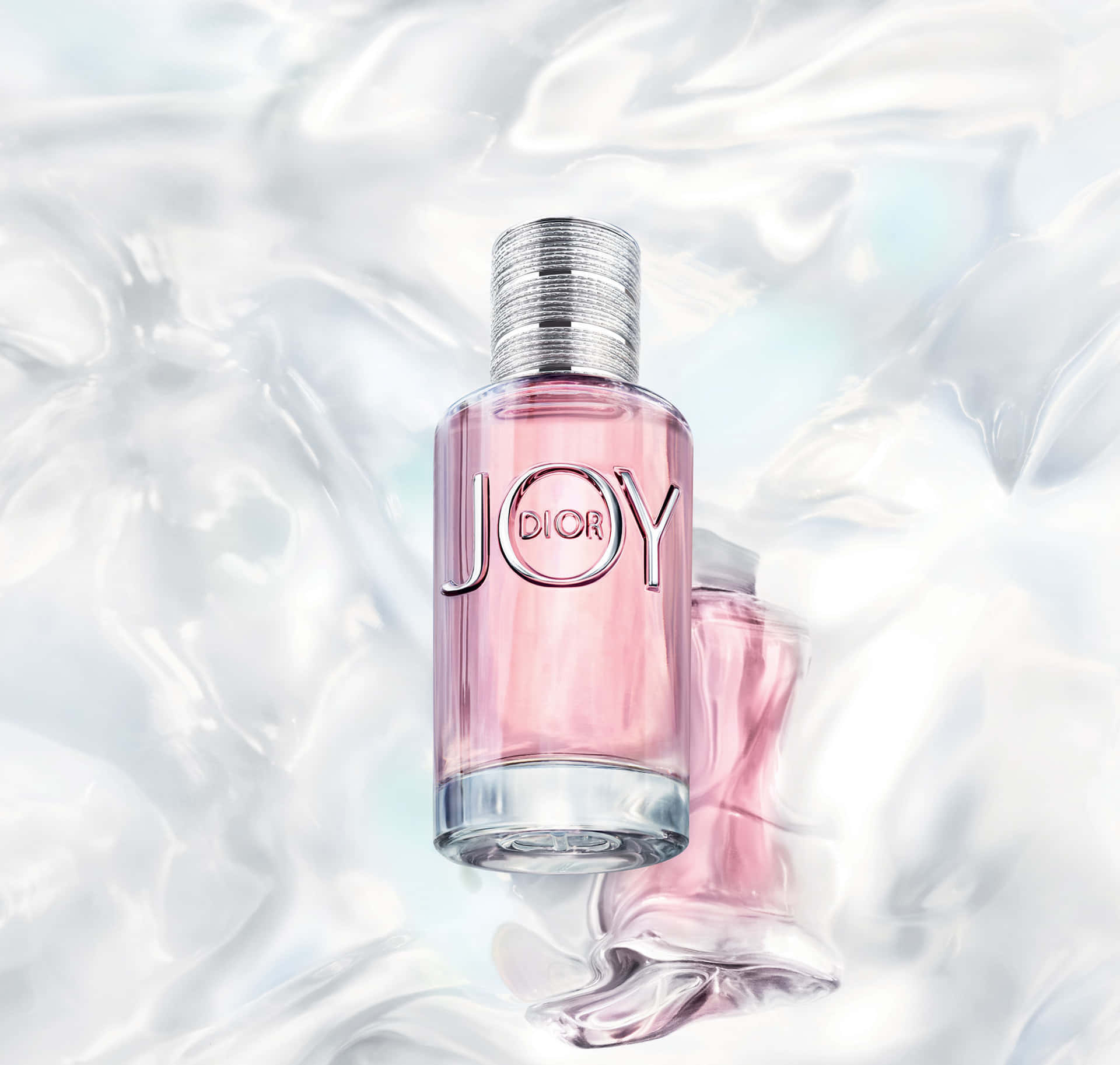 Dior 動態 桌布 壁紙 — 一個粉紅色的Dior Joy香水瓶漂浮在旋轉的彩虹色液體中，附近有另一個瓶子部分浸沒。