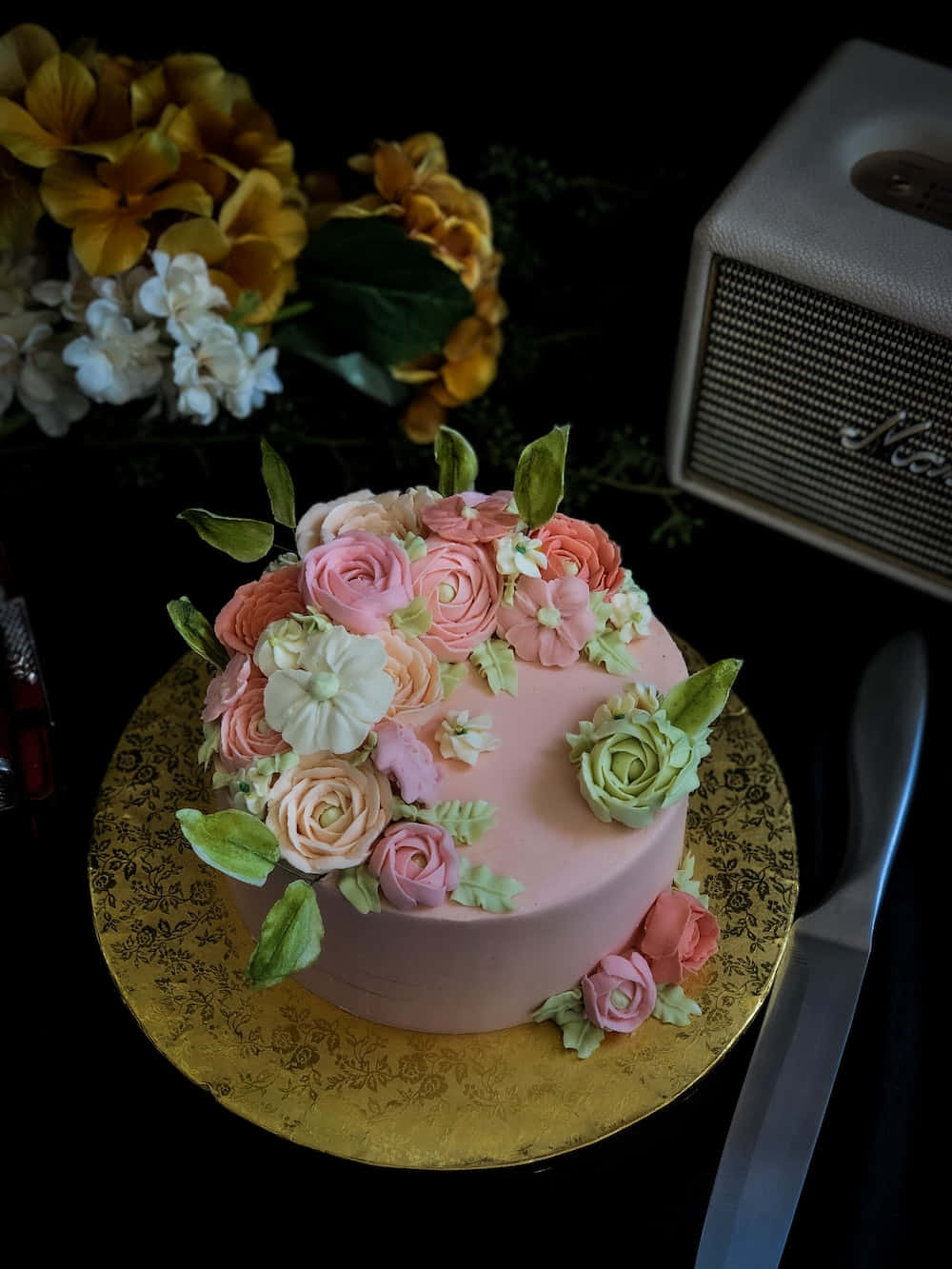 Floral Cake 桌布 壁紙 — 一個粉紅色蛋糕，飾有糖玫瑰和綠葉，放在金碟上，旁邊有一個復古喇叭和鮮花。