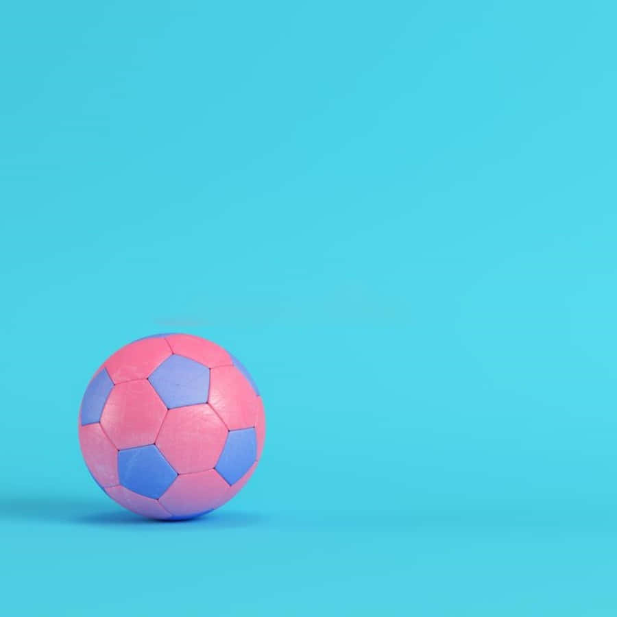 Pink Soccer Ball 桌布 壁紙 — 一個粉藍色足球獨自放在純青色背景上，帶有柔和陰影。