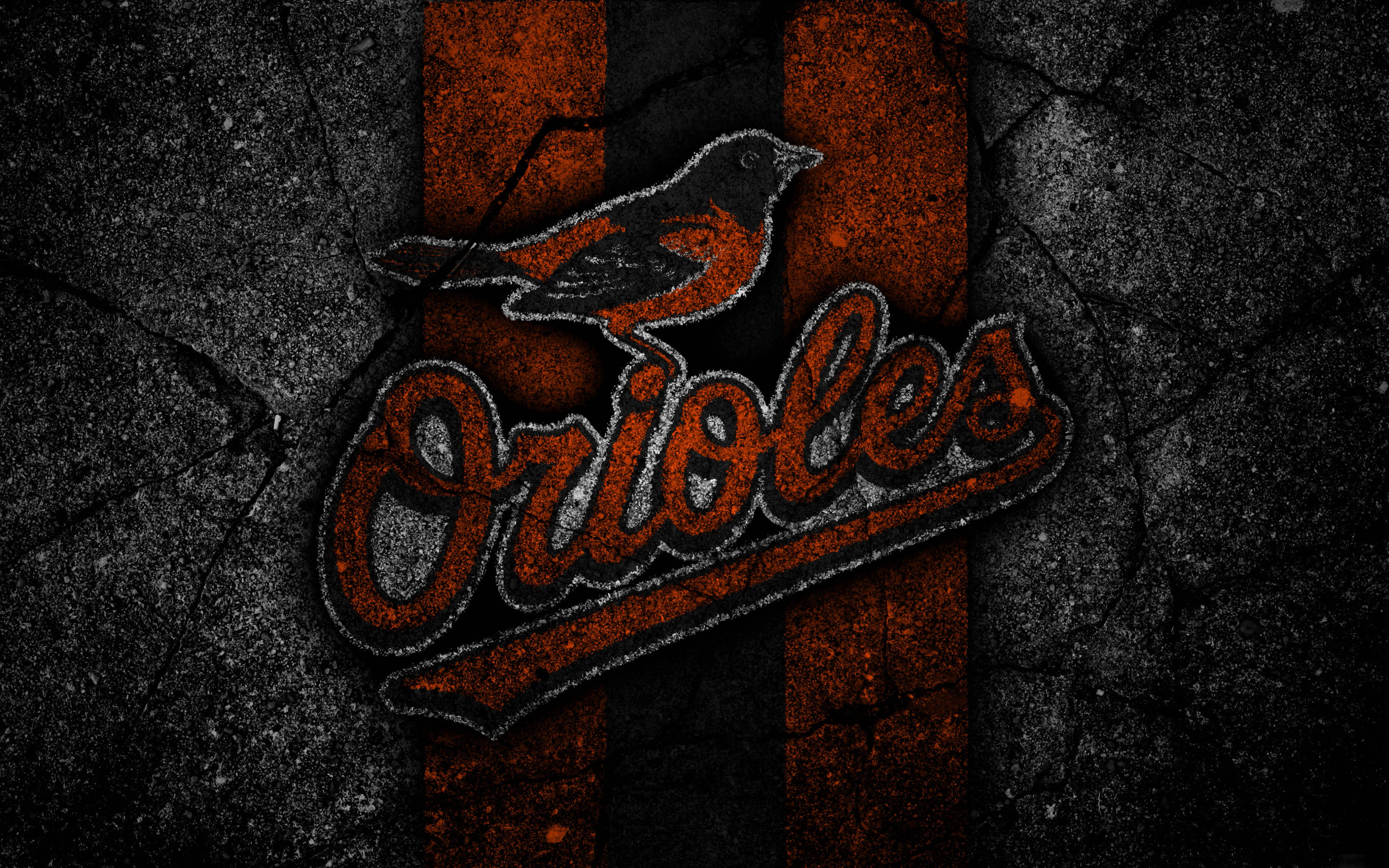 Orioles 桌布 壁紙 — 一個粗糙的巴爾的摩金鶯隊標誌，一隻鳥棲息在風格化文字上方，背景為破裂的黑色和橙色。