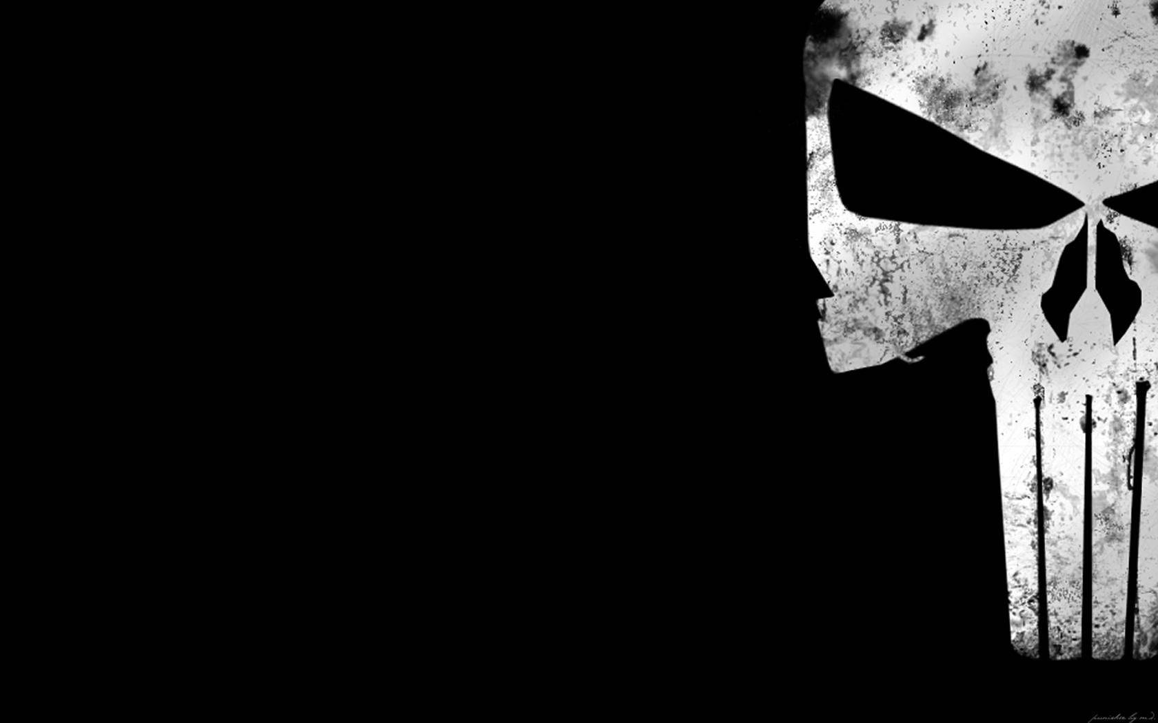 制裁者 桌布 壁紙 — 一個粗糙的白色骷髏標誌，帶有黑色空洞的眼睛和鋸齒狀的牙齒，在純黑色背景上鮮明地矗立。