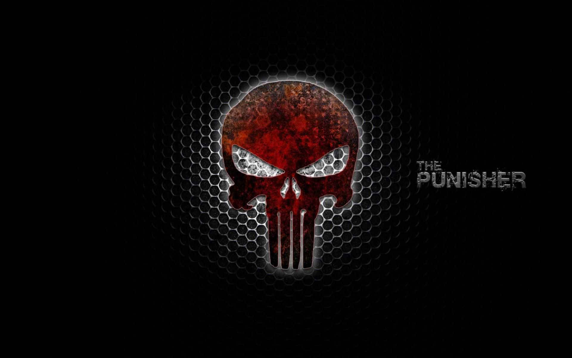 Punisher Logo 桌布 壁紙 — 一個粗糙的紅色骷髏頭，帶有發光的白色眼睛，置於深色六角網格背景上，並帶有「THE PUNISHER」文字。